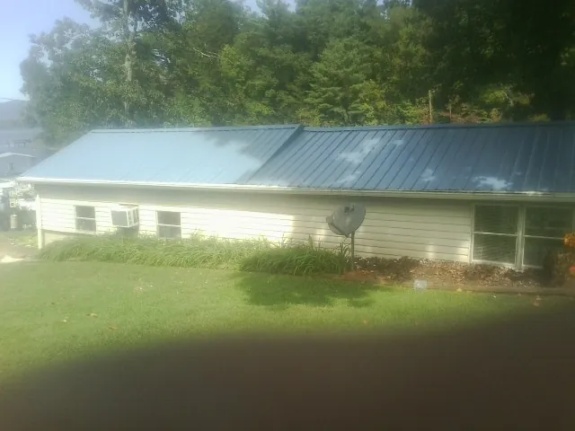 Blue metal roof running the length of a single story home in Kingston